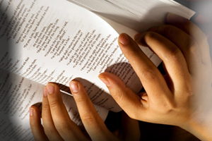 Hands turning Bible pages